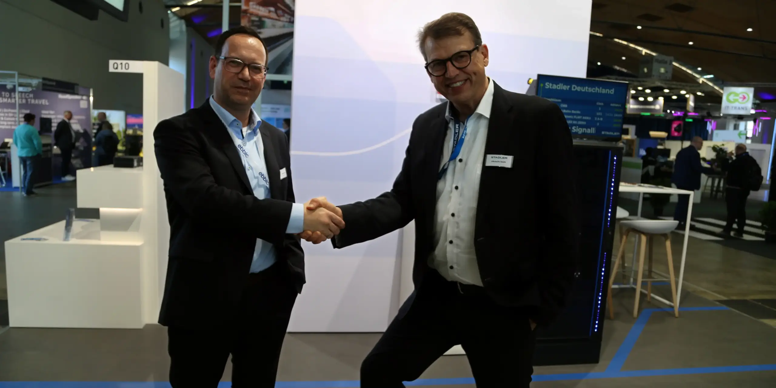 Two men shaking hands an smiling