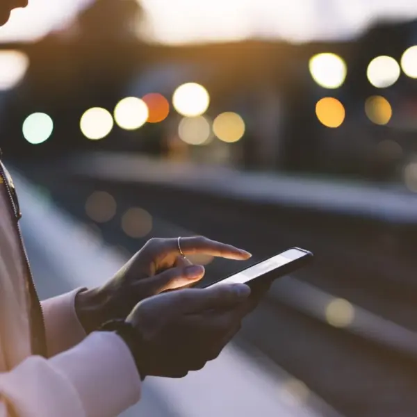 Person on phone at train platform