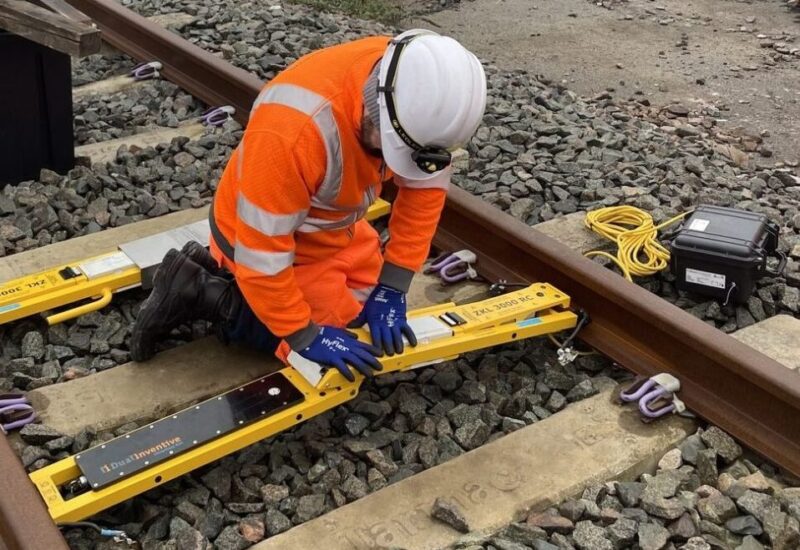 Man wearing hard hat and high vis working on railway track