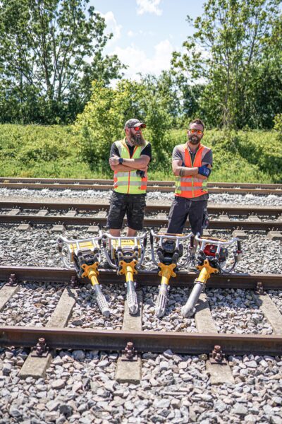 Two men with ROBEL tamping machines