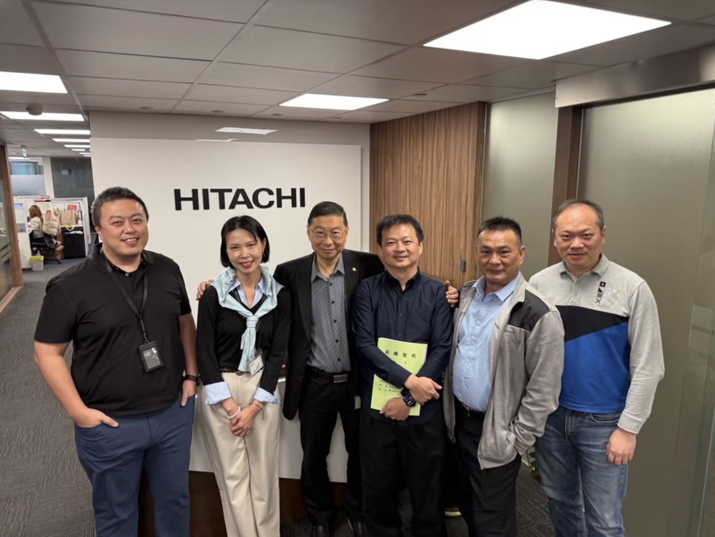 A group of people stood in Hitachi's office