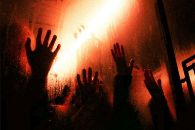 Shadowy hands on a window
