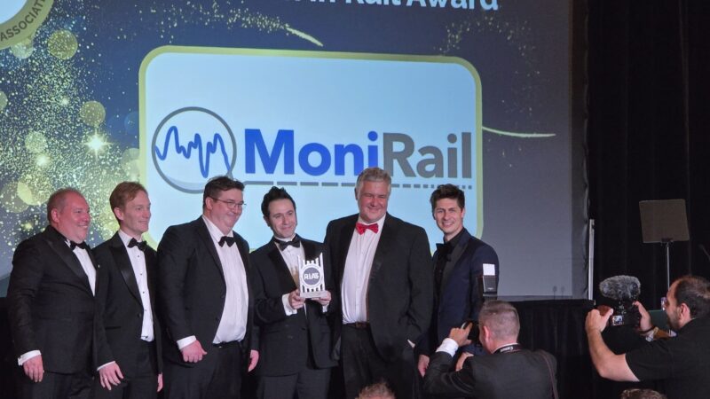 MoniRail team celebrating on stage after winning the SME Growth in Rail Award at the RIA RISE Awards 2026, with the MoniRail logo displayed on screen behind them.