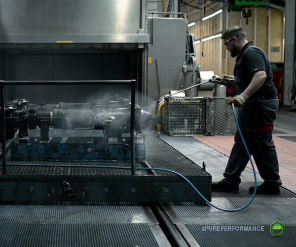 High-pressure cleaning of a bogie assembly in a rail maintenance workshop. DST-CHEMICALS water-based formulations handle heavy contamination including oils, greases and brake dust.