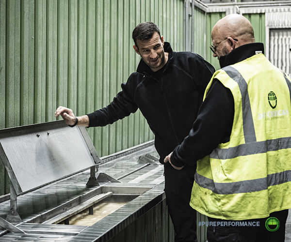 A DST-CHEMICALS service technician reviewing the cleaning process with a workshop operator. On-site process evaluation is a core part of the Pure Performance approach.