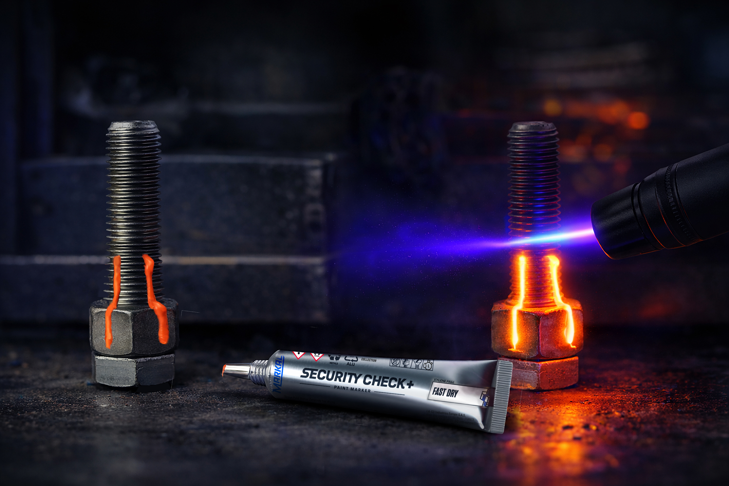 MARKAL Security Check+ Fast Dry fluorescent orange paint applied to a railway fastener