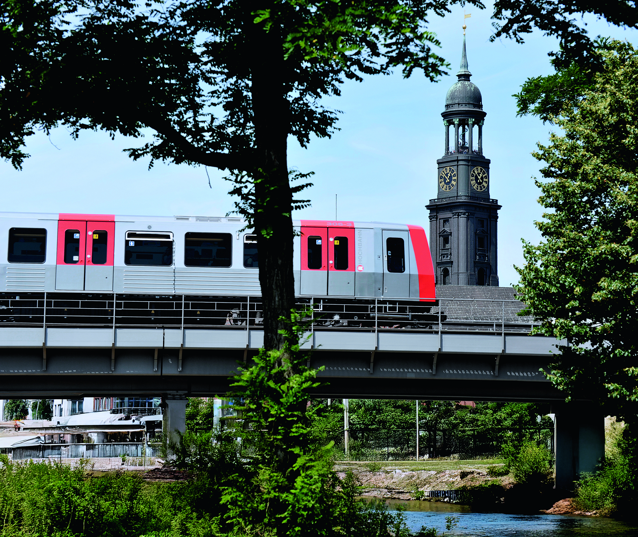 Hamburger Hochbahn subway train crossing a bridge in Hamburg, with St. Michaelis church tower in the background