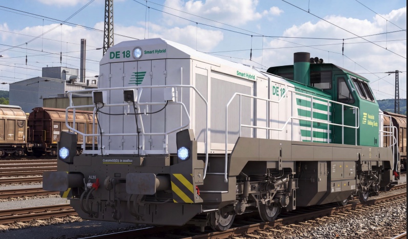 Vossloh DE 18 SmartHybrid locomotive on rail tracks with overhead catenary lines