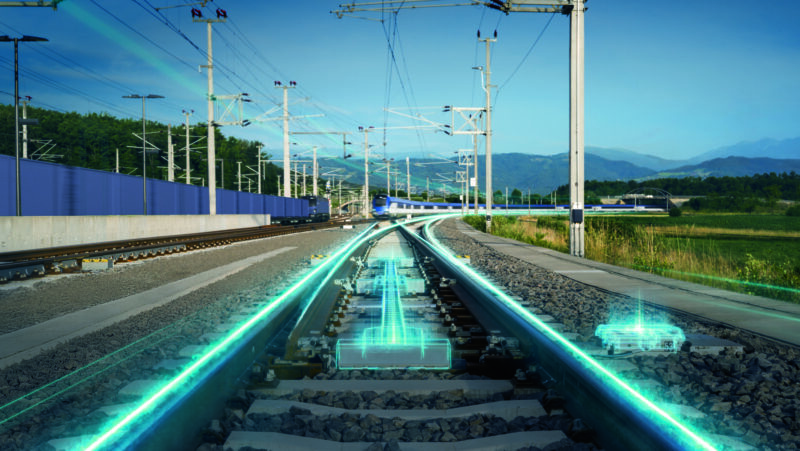 Digital rail track and turnout with glowing blue sensor overlays representing smart monitoring technology