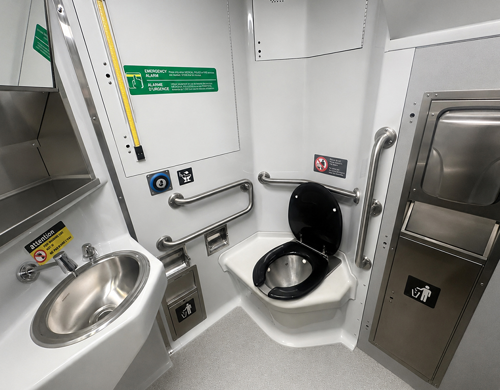 Washroom module made by INPS inside a Bombardier BiLevel Coach with sink, toilet and grab rails