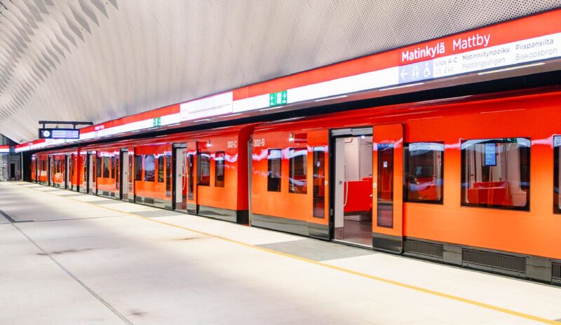 Orange Helsinki Metro train waiting at Matinkylä station platform