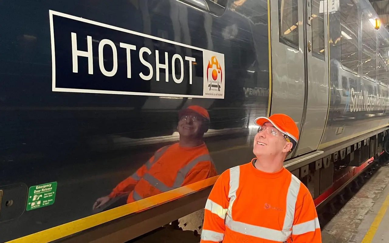 One Big Circle systems engineer beside South Western Railway’s Class 450 train named Hotshot