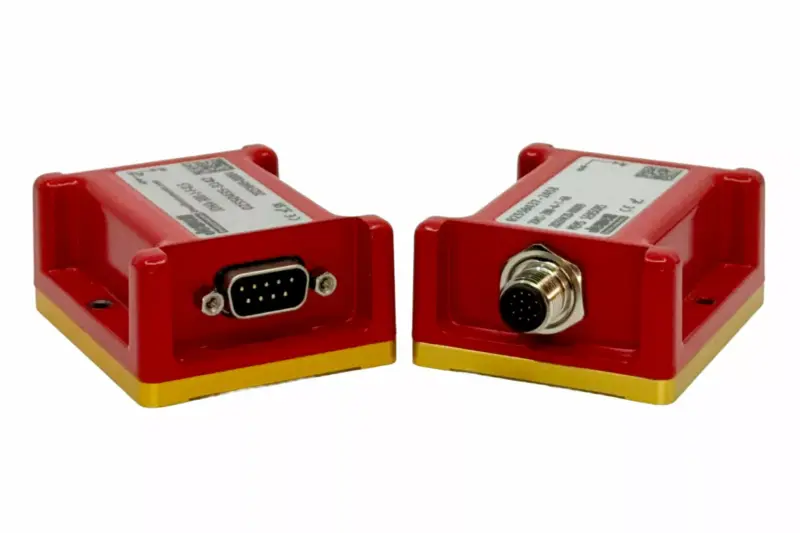 Two red Jewell Digital Ruby MEMS sensors with gold-coloured bases on a white background, one fitted with a DB9 connector and the other with a circular M12 connector.