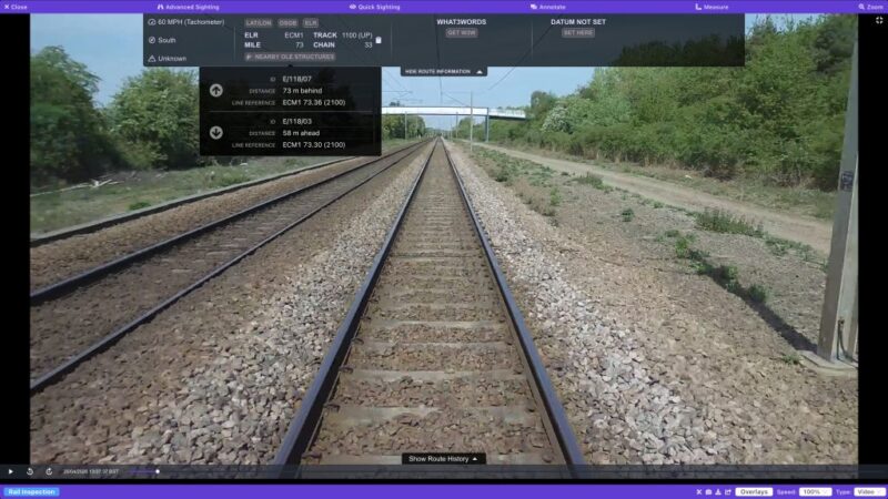 Screenshot of AIVR fullscreen mode showing forward-facing footage of a straight railway track, with a Nearby OLE Structures panel listing structure IDs E/118/07 and E/118/03 with their distances behind and ahead and line references