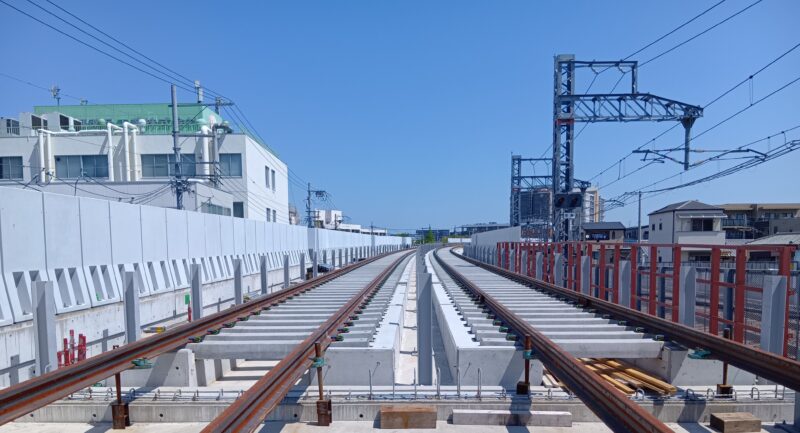 Elevated twin-track viaduct under construction near Awaji Station in Osaka, with rails fastened to concrete sleepers using Pandrol FastClip