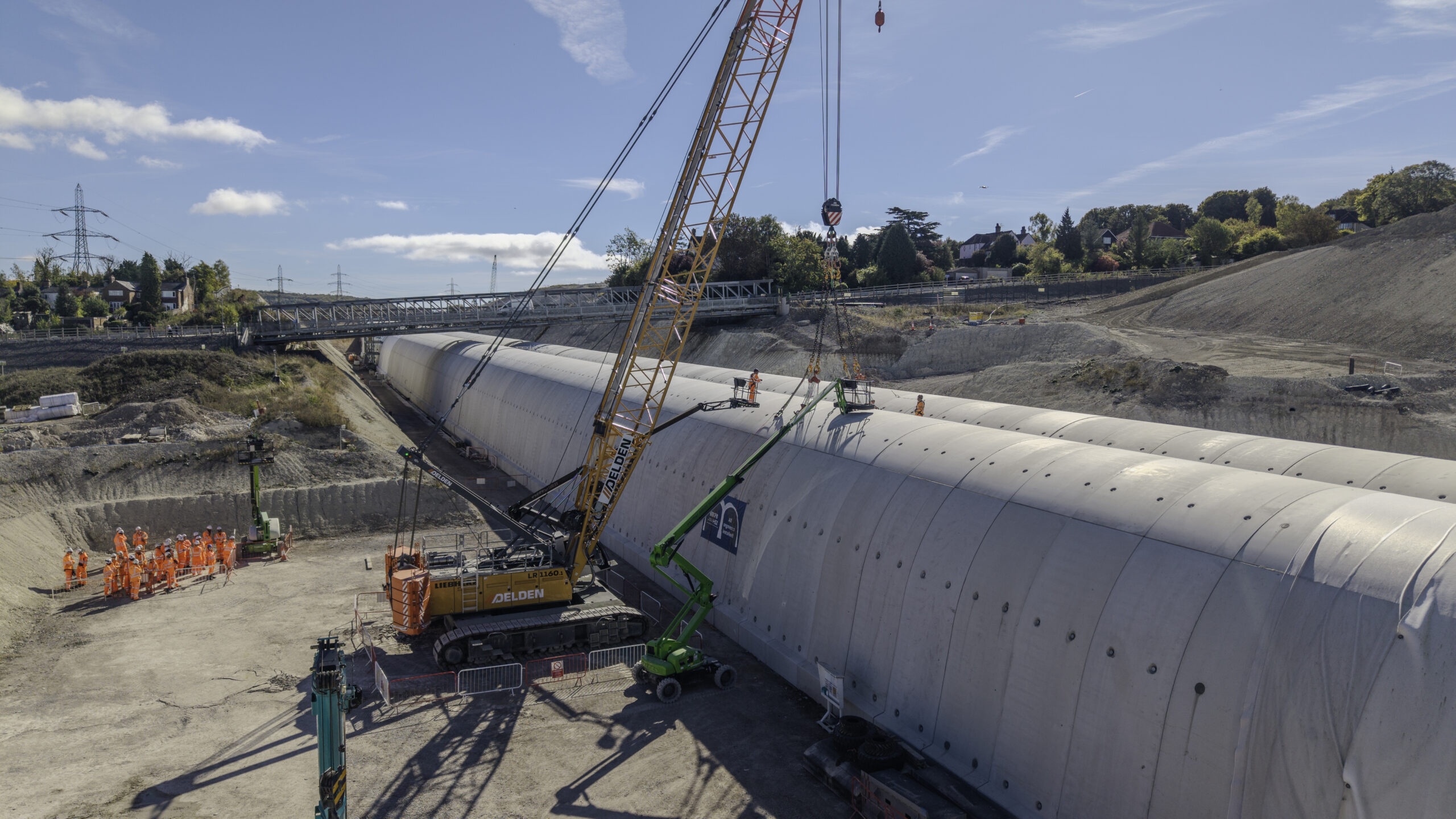 The last segment being lifted into poistion at Wendover green tunnel as the site team look on October 2026