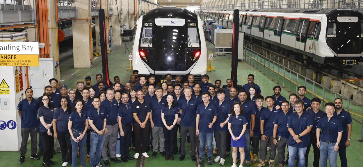 A team of Alstom engineers surrounding a train